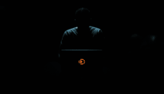 a person in a dark room with laptop battling porn and drug addiction